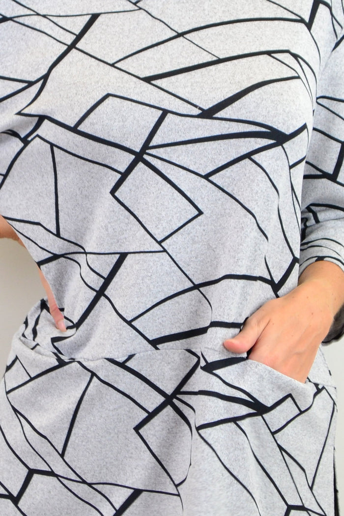 Caroline Morgan abstract lines print tunic top featuring a flowing design with bold, modern line patterns on lightweight fabric.