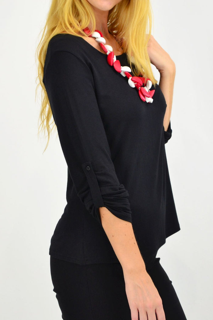Lilia black button-up long sleeve basic top displayed on a hanger, showcasing its classic design and smooth fabric.