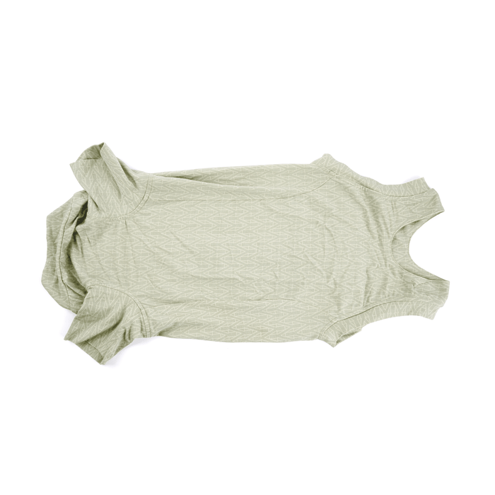 White background with a underneath view of a geometric green bodysuits for dogs pictured.