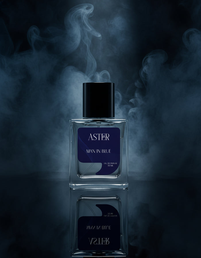 Perfume bottle labeled 'Aster Man in Blue' with smoke effect on a dark background