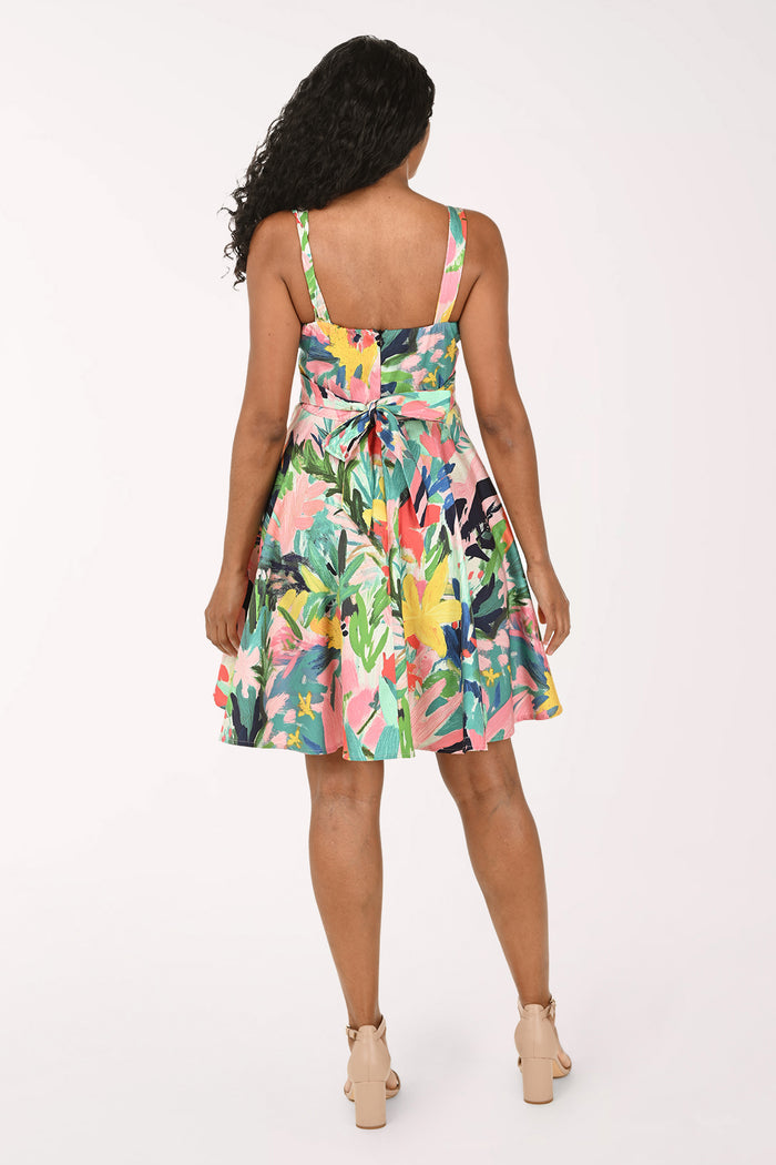 Woman wearing a colorful floral dress on a white background