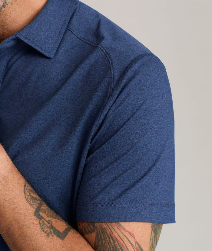 Model wearing a Performance Polo in navy.