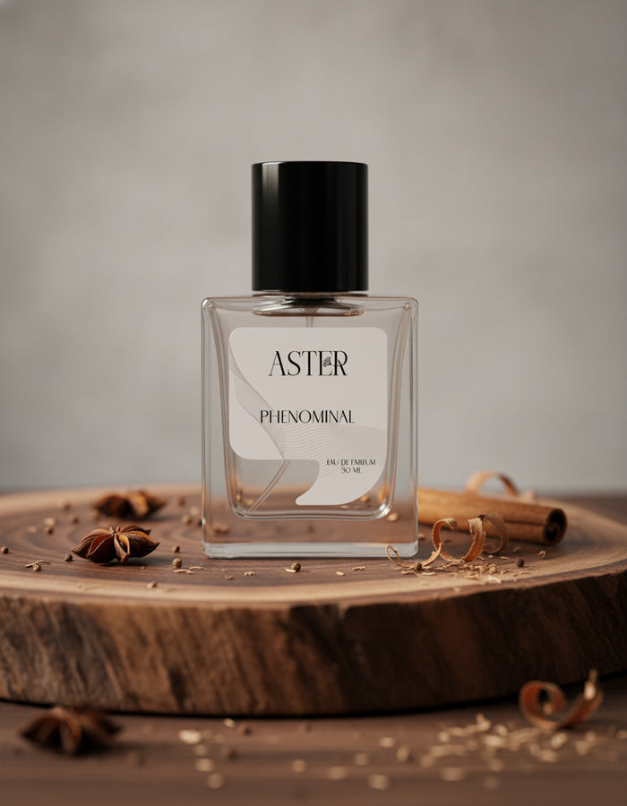 Aster Phenominal perfume bottle on a wooden surface with spices
