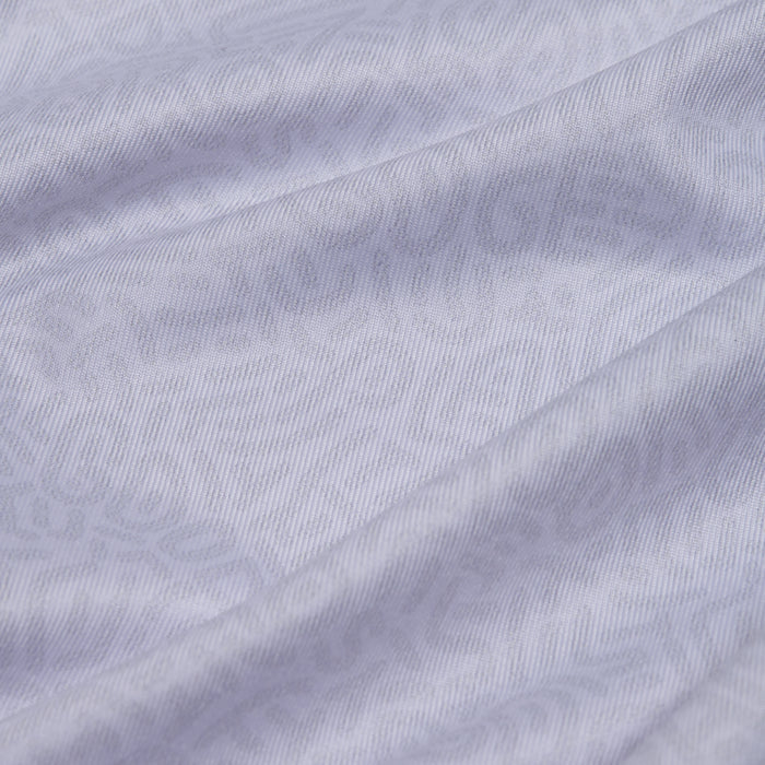 Close-up of the Stealth Mode - Light - Women's Polo's light gray fabric, showcasing a subtle wavy geometric pattern, soft texture, and moisture-wicking properties for lightweight comfort and a sense of depth.