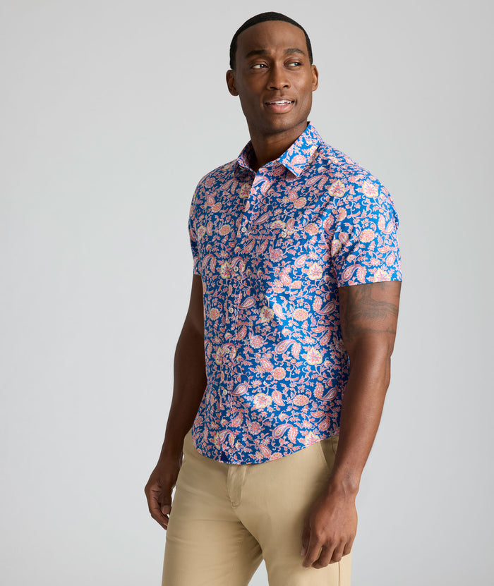 Model is wearing UNTUCKit Quarry cotton linen shirt in pink print.
