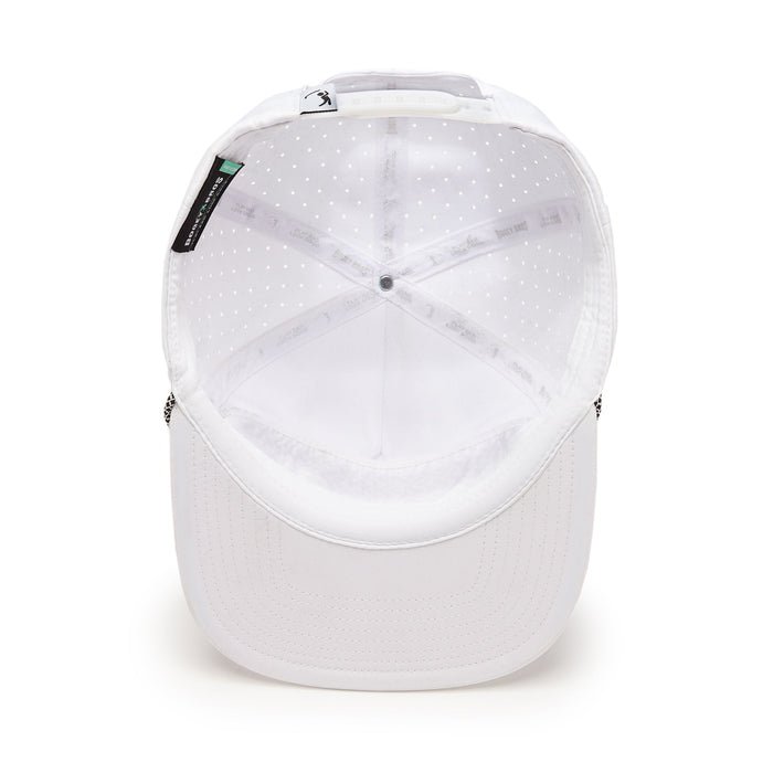 The TX20 - Unstructured Flat Bill Hat - Snapback is white with a flat brim, mesh-like interior lining with small perforations, fabric strips printed with logos, and a white adjustable plastic snapback strap at the back.
