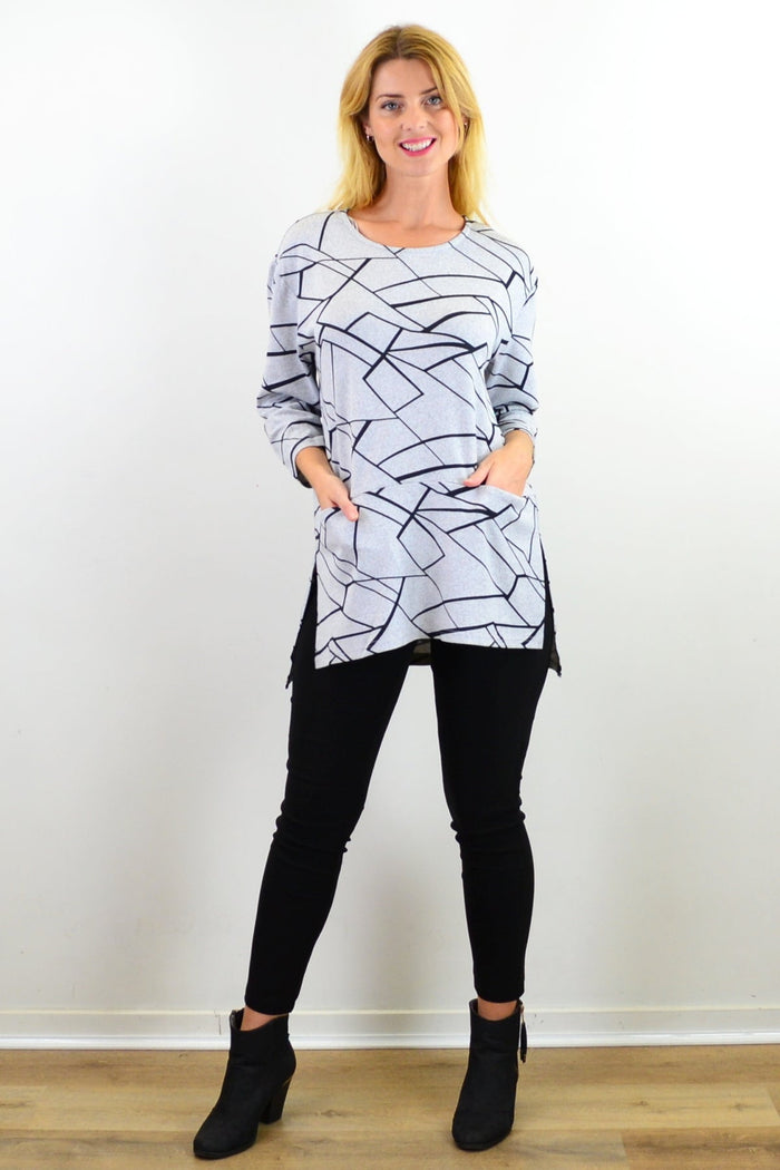 Caroline Morgan abstract lines print tunic top featuring a flowing silhouette and vibrant geometric design.