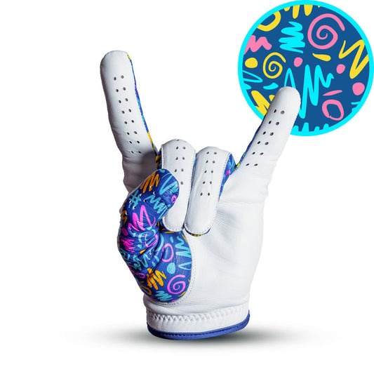 The Booyah - Glove is a white cabretta leather golf glove with colorful, abstract patterns in yellow, pink, and blue on turquoise. Featuring squiggles, zigzags, and dashes, it makes the rock on hand gesture for precision fit style.