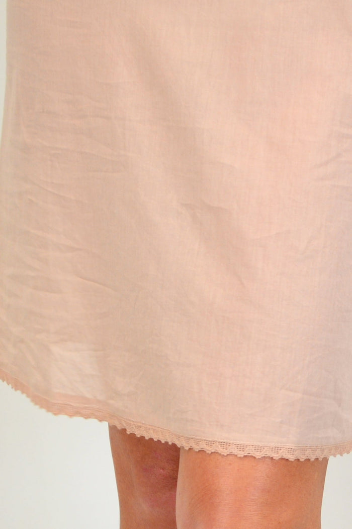 Nude cotton slip by I Love Tunics with delicate lace trim, soft fabric, and simple design, perfect for comfortable basics.