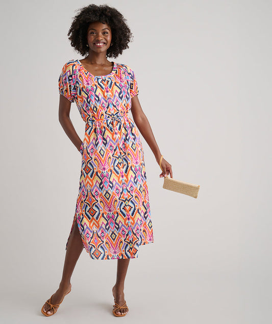 Model is wearing UNTUCKit Marguerite printed orange dress.
