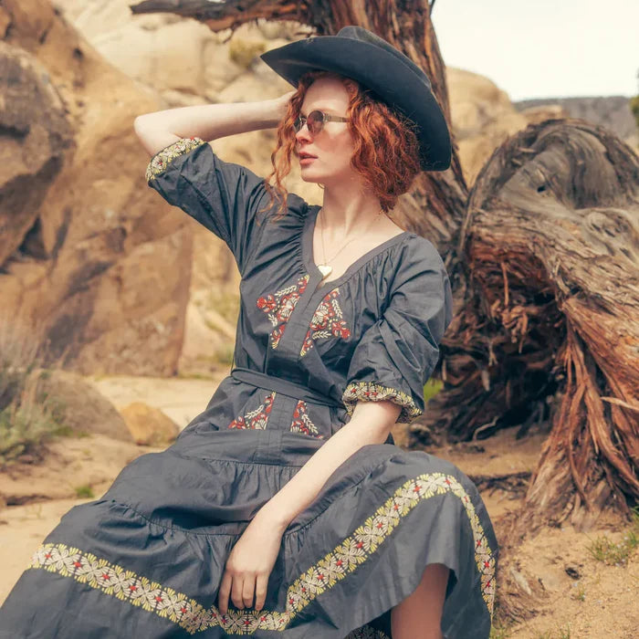 Mariana Dress in Onyx Gray with model in desert