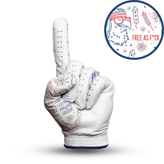 The 'Merica - Glove is a white golf glove shaped like a hand making a “number one” gesture, with red and blue fireworks, “FOUNDING FATHERS FREEDOM,” and an inset eagle head in bandana, “FREE AS F*CK” text—all in patriotic colors.