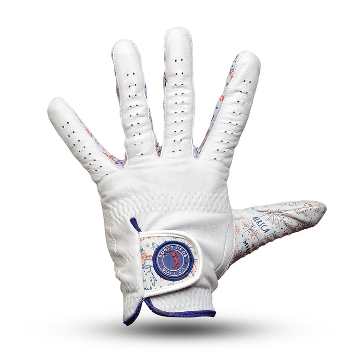 The 'Merica - Glove is a white Cabretta leather golf glove with blue and orange map-inspired accents, ventilation holes, a precision fit, and a blue round logo on the adjustable wrist strap. Shown palm forward on a white background.