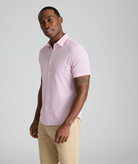 Model is wearing UNTUCKit Ireton short sleeve performance shirt in red.