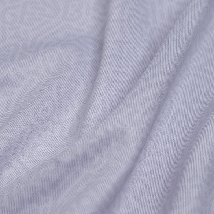 Close-up of the Stealth Mode - Light - Polo’s light gray fabric, featuring soft folds and subtle geometric patterns. Its smooth, slightly ribbed texture ensures lightweight comfort and moisture-wicking for all-day freshness.