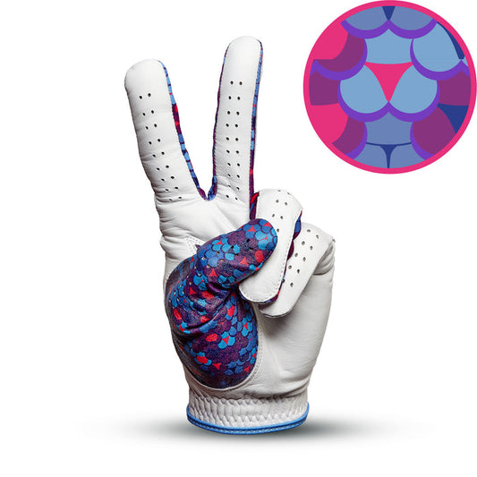The Whale Tail - Glove features white Cabretta leather with blue, purple, and pink scales forming a peace sign. A close-up inset shows its vivid overlapping colors and precise fit on a bright white background.