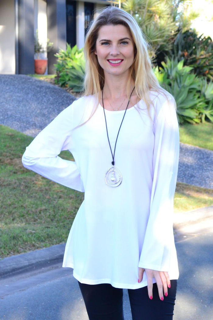 White Lilia long sleeve button-up tunic, a basic top with a classic collar and front buttons, displayed on a plain background.