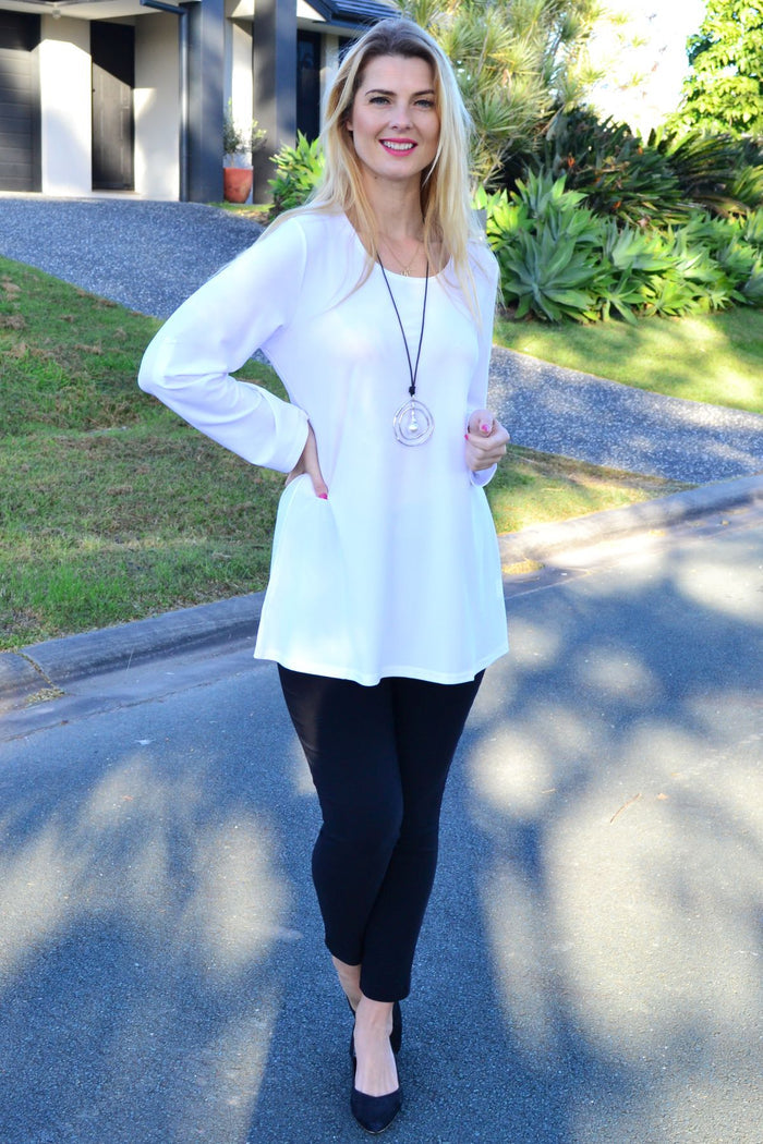White Lilia button-up long sleeve tunic featuring a classic collar, front buttons, and a relaxed fit for versatile casual wear.