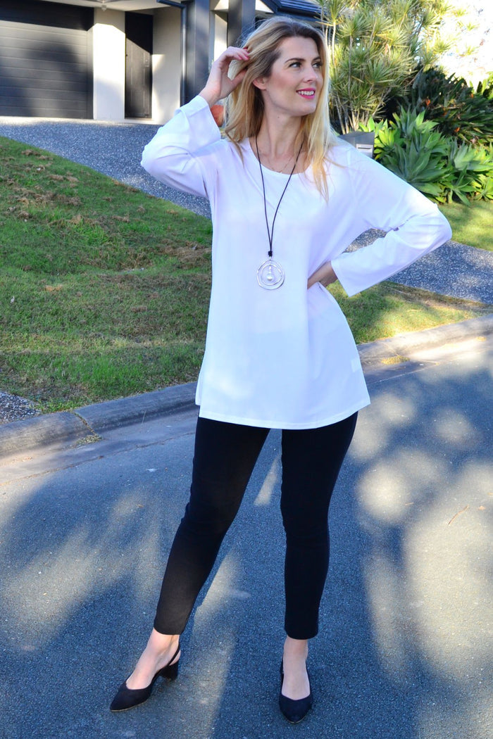 White Lilia basic button-up long sleeve tunic with a classic fit, featuring a collar and button front, ideal for casual or office wear.